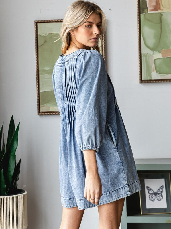 Veveret Washed blue denim romper with a ruched bodice and bow tie v neckline
