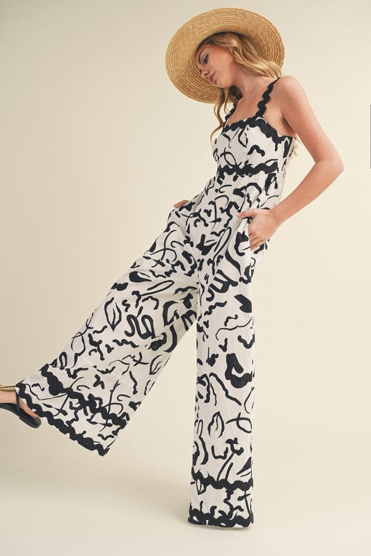 &merci White and black abstract print wide leg jumpsuit with scalloped ric rac trim