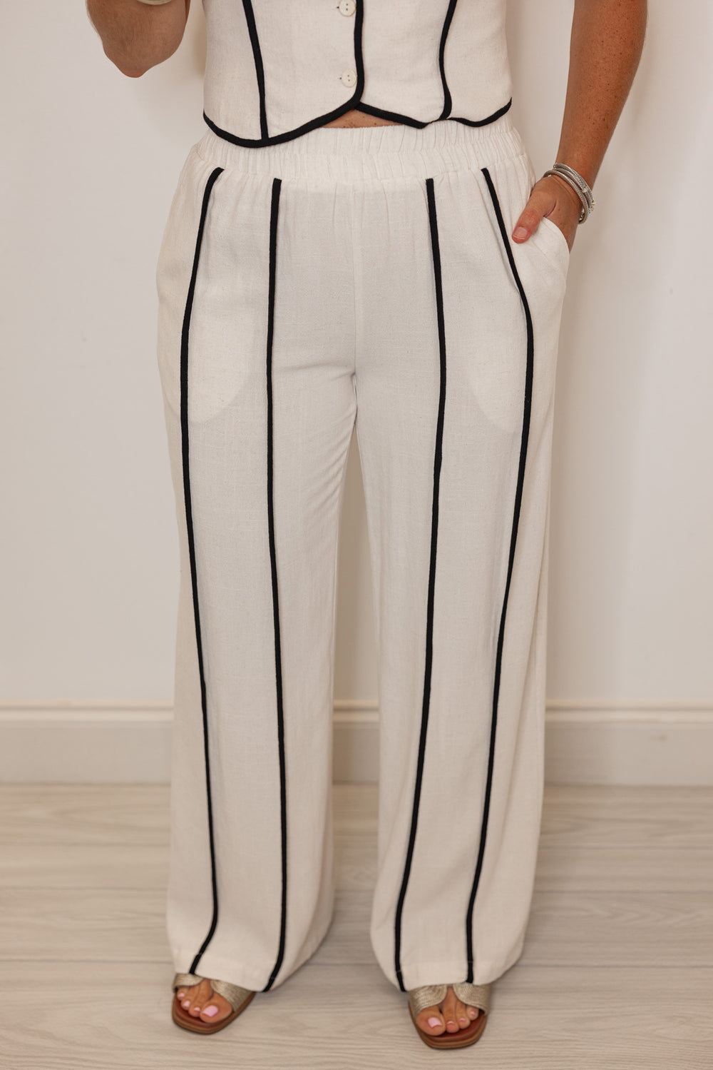 Women's natural linen wide leg pants with black striped trim by Illa Illa showing up close full front view