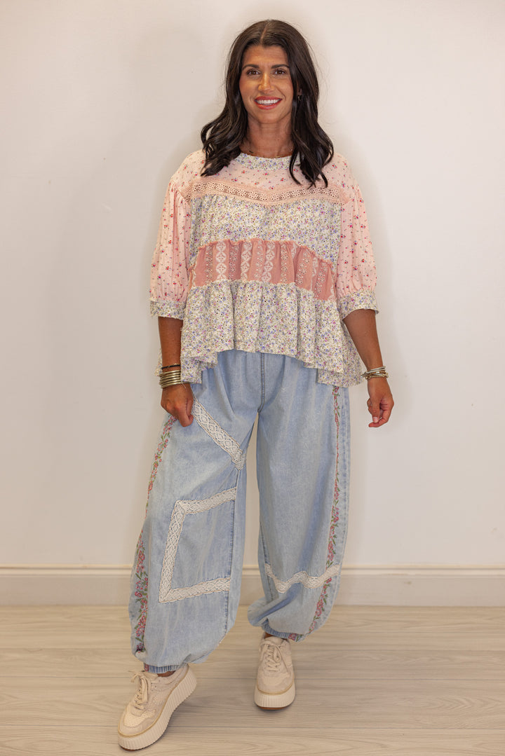 Women's wide leg jogger pants with pink floral embroidery trim and lace details by POL showing full front view