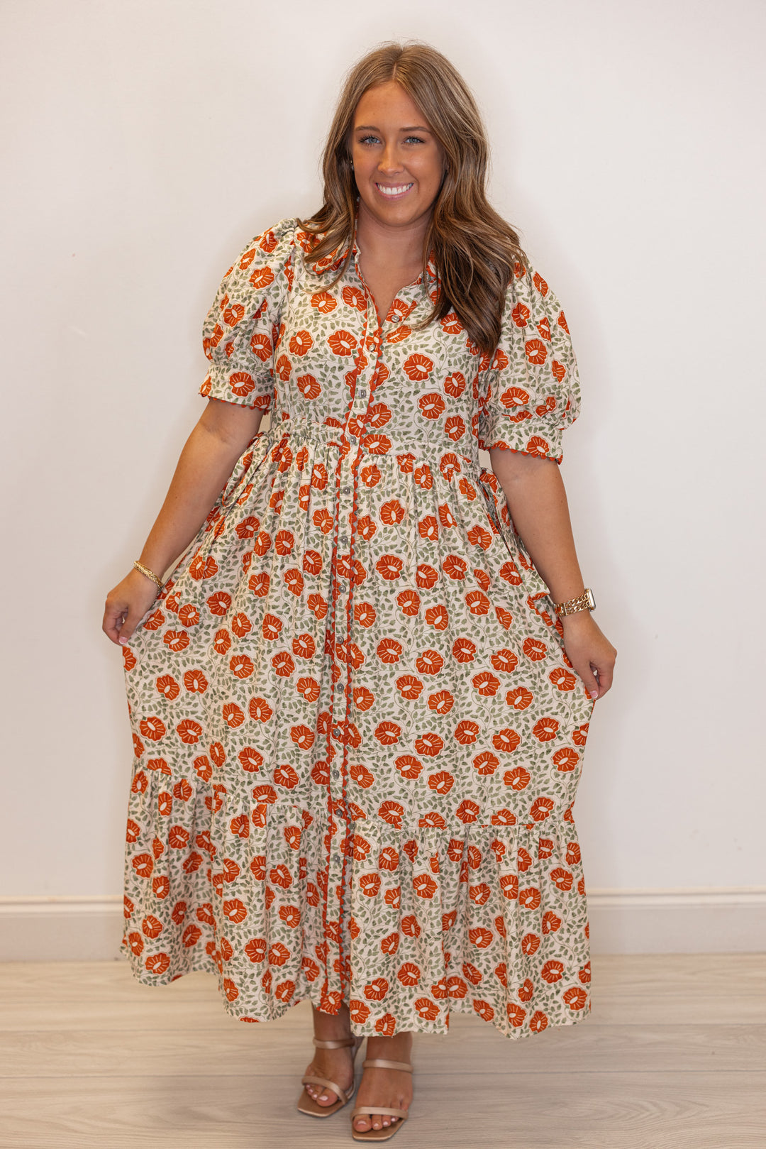 Women's cream button front midi dress with rust floral print by Entro showing tiered bottom hem